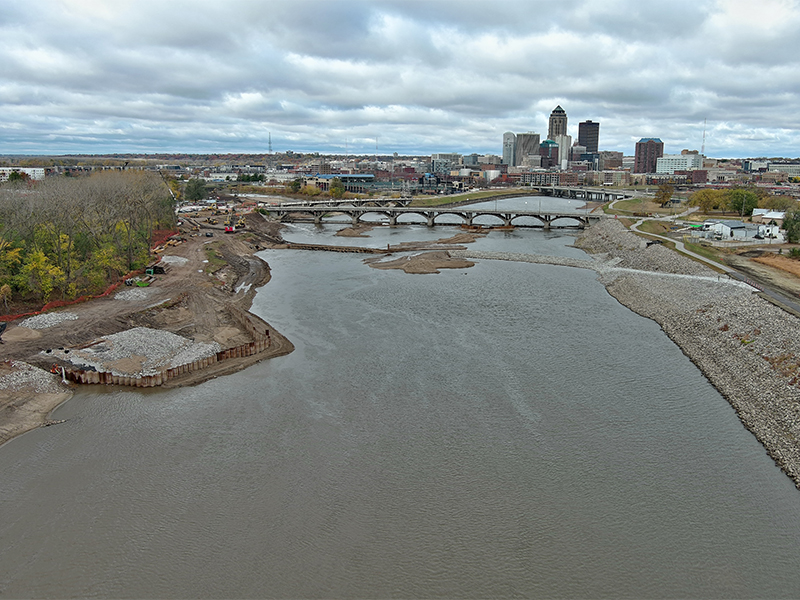 An aerial view of the Des Moines River, with downtown Des Moines in the background, shows the levee raise construction for Phase C of the city's levee system upgrade project.
