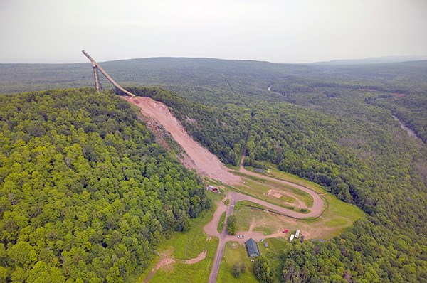 The Copper Peak ski jump superstructure and landing hill on a forested hillside near Ironwood, Michigan
